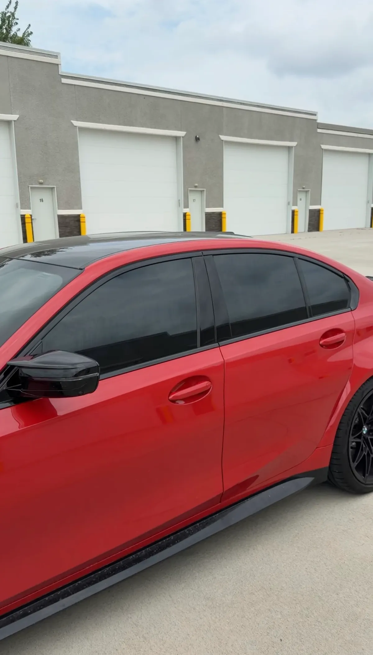 Red BMW side profile after ceramic window tint