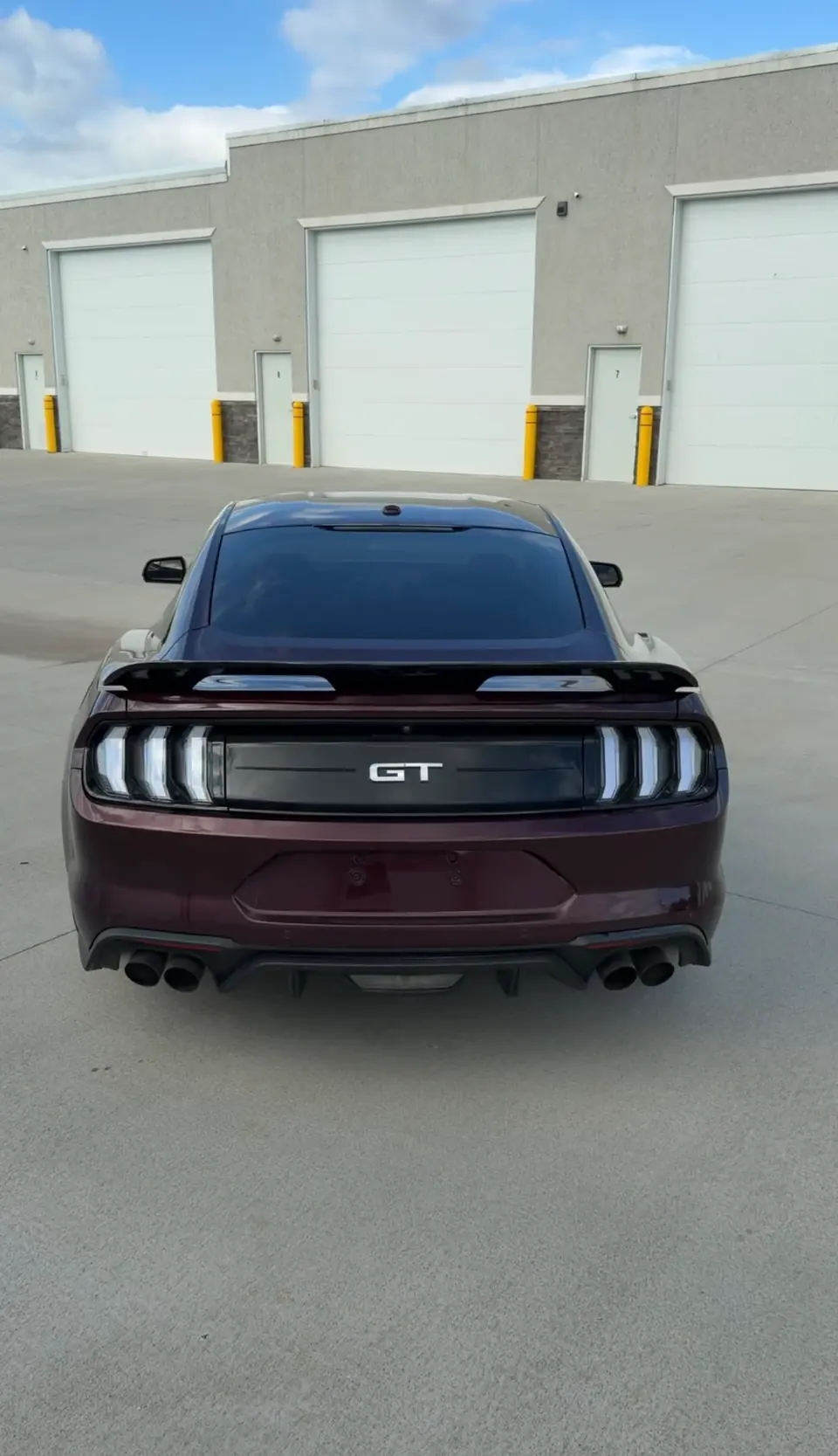 Burgundy Mustang GT rear view after tinting